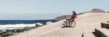 Manual wheelchair K-Series young woman on the beach