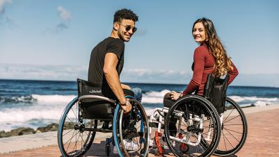 Manual wheelchair K-Series couple in front of ocean